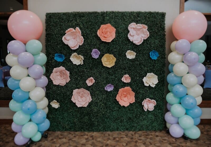 photo wall with green hedge background colorful balloons at succulent party